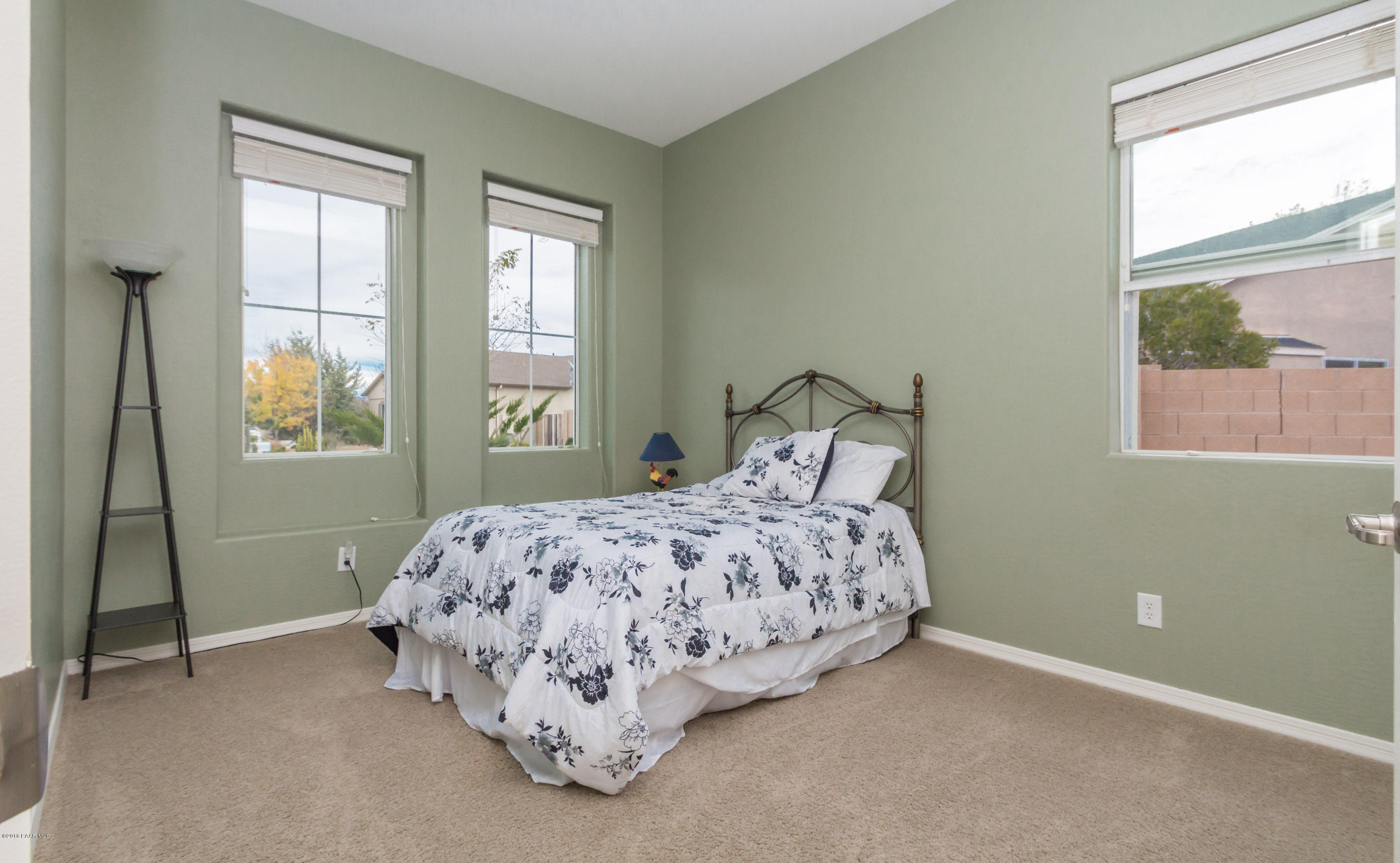 7887 East Mesteno Road Prescott Valley, AZ 86315 - Photo 15 of 30 a bed sitting in a bedroom next to a window