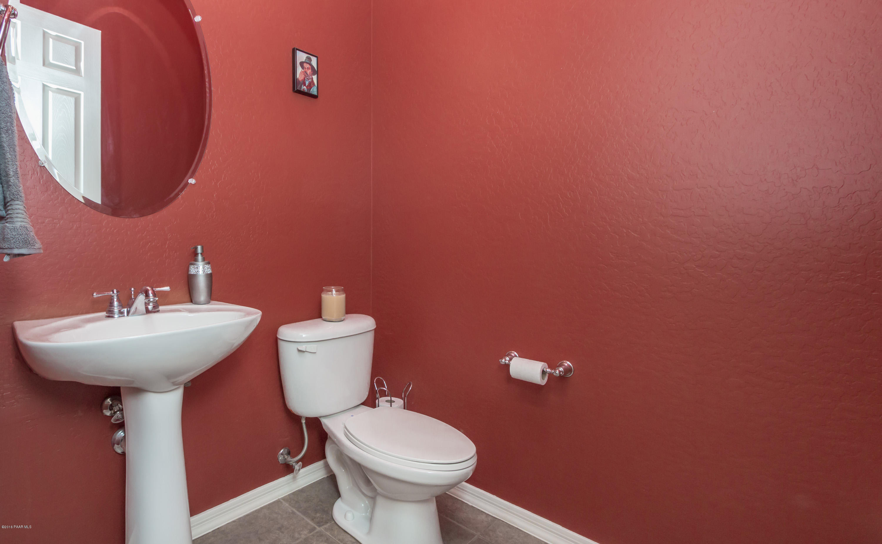 7887 East Mesteno Road Prescott Valley, AZ 86315 - Photo 20 of 30 a bathroom with a sink mirror and toilet