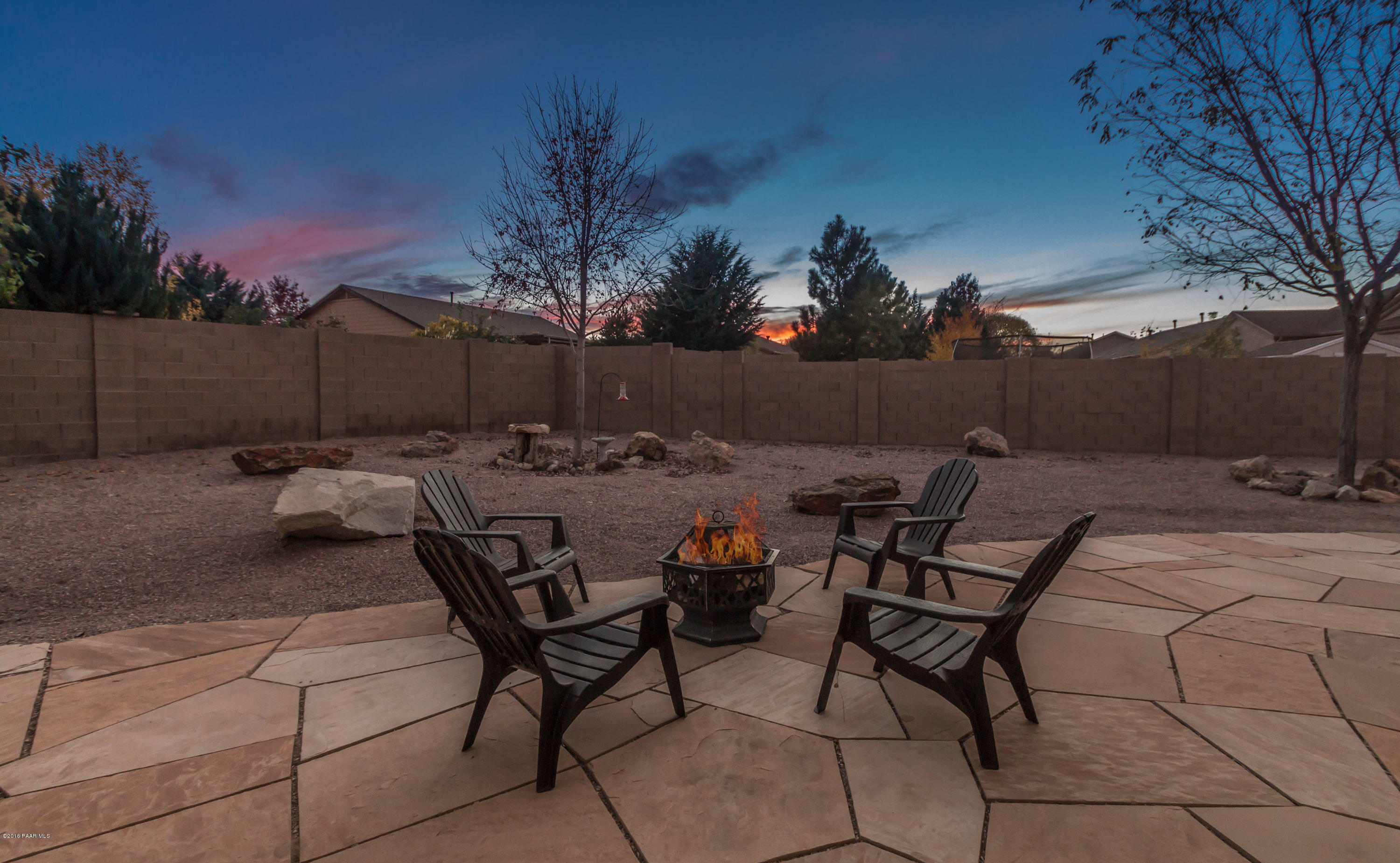7887 East Mesteno Road Prescott Valley, AZ 86315 - Photo 24 of 30 a backyard of a house with table and chairs