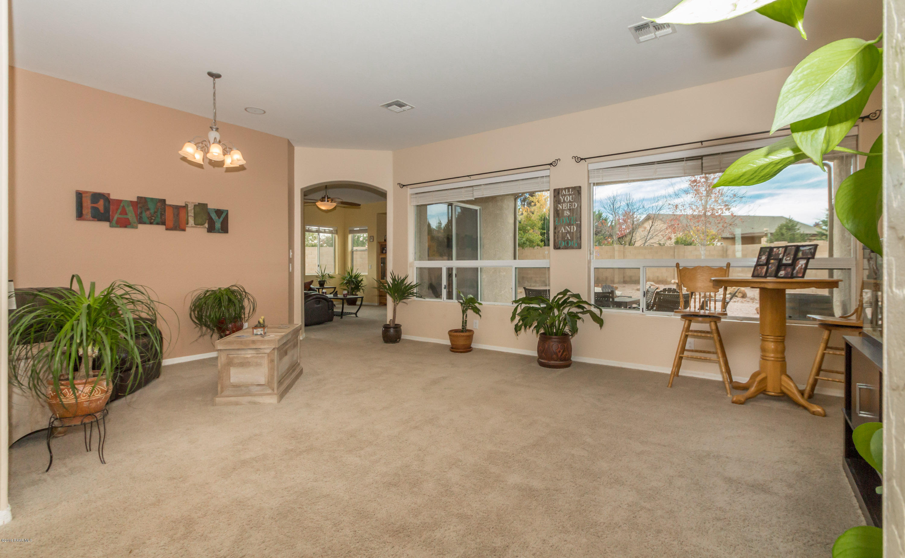 7887 East Mesteno Road Prescott Valley, AZ 86315 - Photo 5 of 30 a view of a livingroom with furniture and a floor to ceiling window