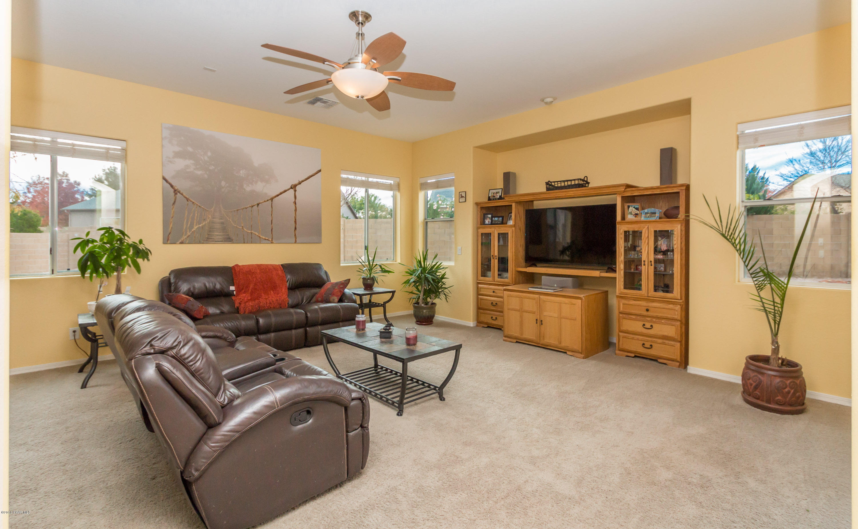 7887 East Mesteno Road Prescott Valley, AZ 86315 - Photo 7 of 30 a living room with furniture and a flat screen tv