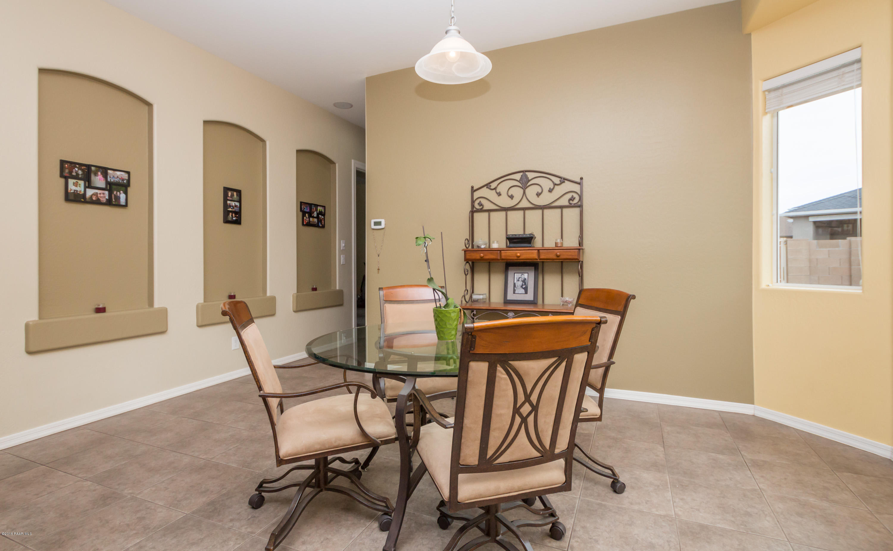 7887 East Mesteno Road Prescott Valley, AZ 86315 - Photo 8 of 30 a view of a dining room with furniture and a window