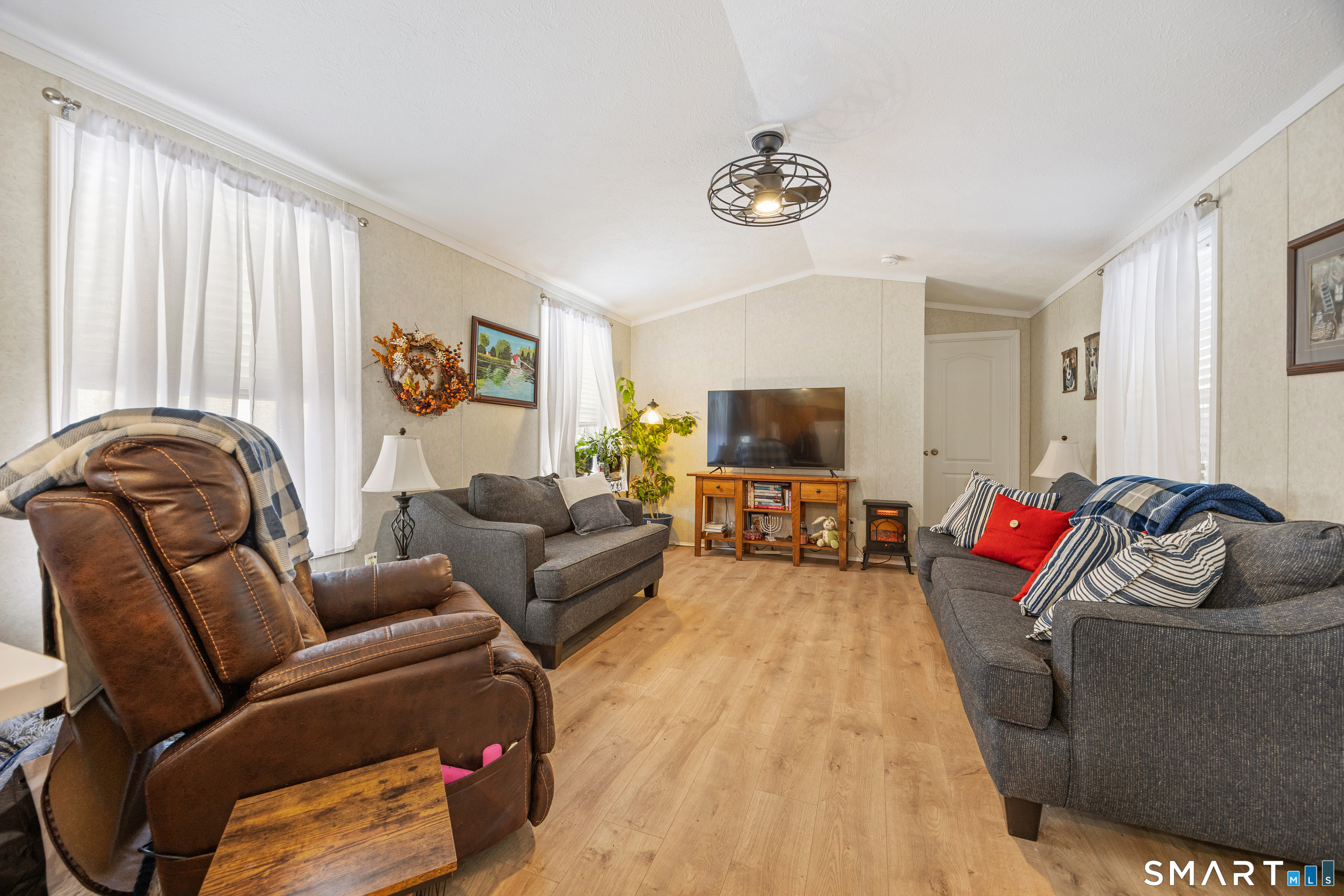 10 Meadow Road Southington, CT 06489 - Photo 6 of 23 a living room with furniture and a flat screen tv