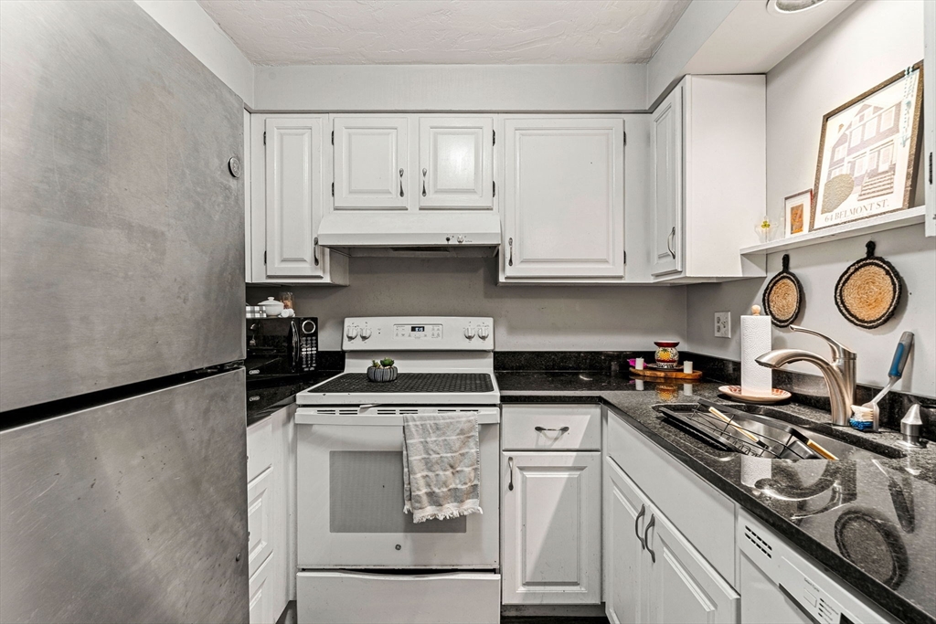 23 Magnolia Street, Unit 2 Attleboro, MA 02703 - Photo 10 of 32 a kitchen with white cabinets and appliances