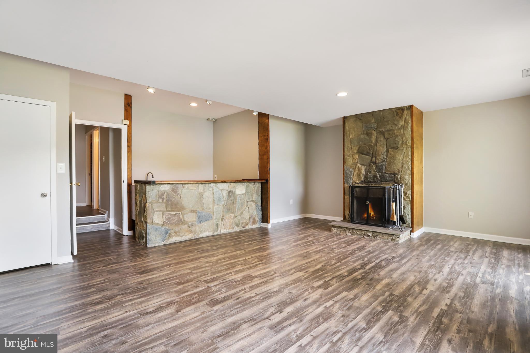 2005 Lakebreeze Way Reston, VA 20191 - Photo 14 of 20 an empty room with wooden floor and a fireplace