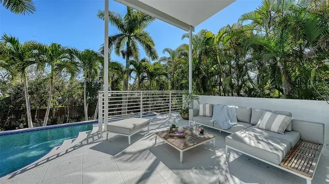 a view of a patio with couches and a table and chairs with garden view
