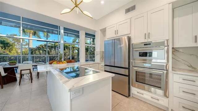 a kitchen with stainless steel appliances granite countertop a refrigerator and a stove