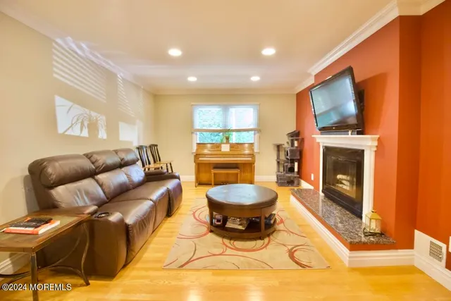 a living room with furniture a fireplace and a flat screen tv