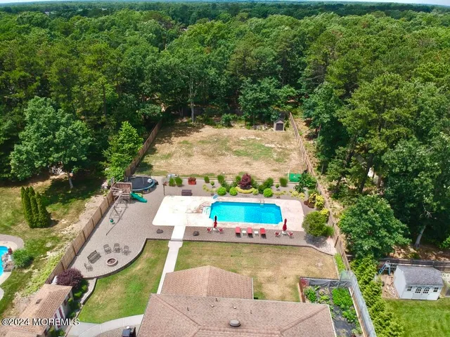 an aerial view of a house with a swimming pool