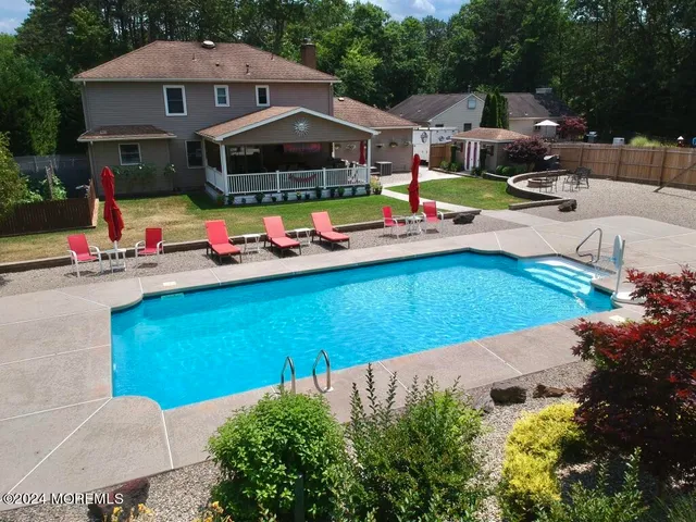 an aerial view of a house with swimming pool and patio