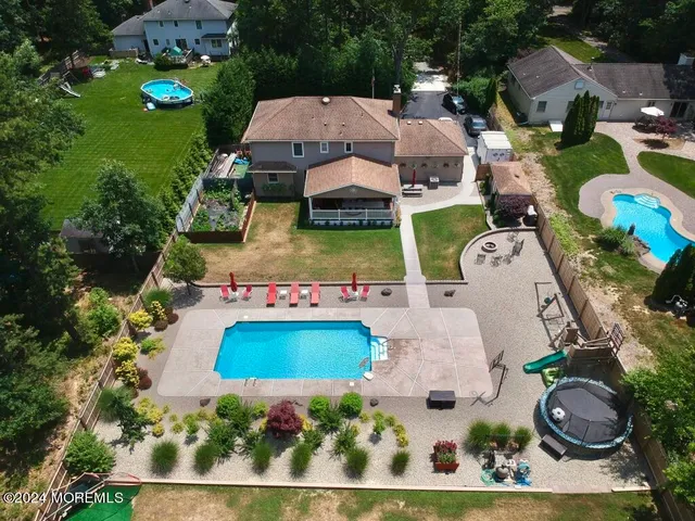 an aerial view of house with yard swimming pool and outdoor seating