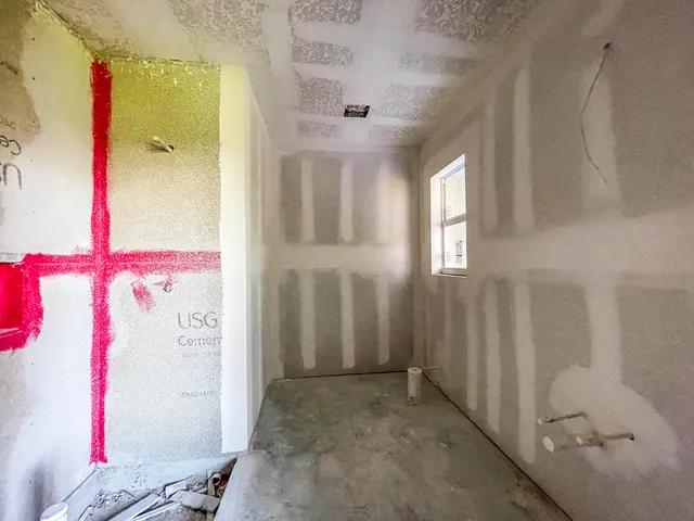 an outdoor space with wooden wall