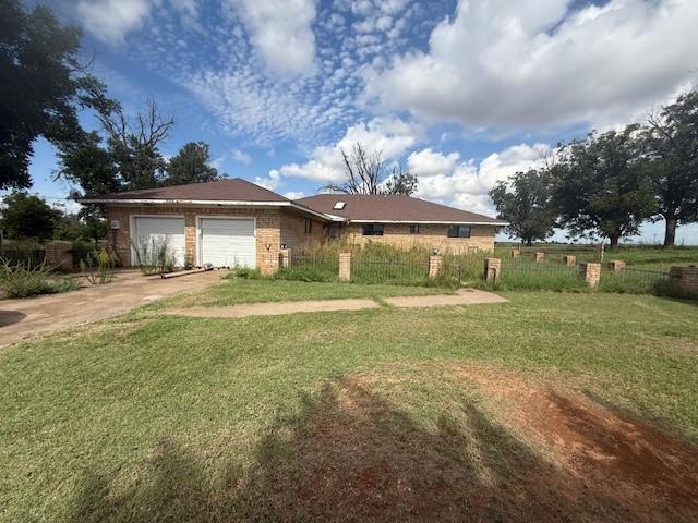 View of front of property with driveway, an attached garage, and brick siding