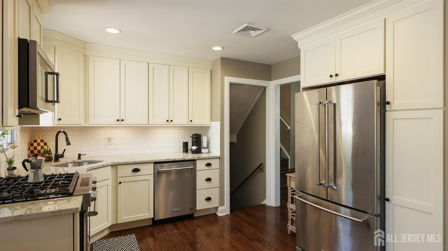 47 Miliken Road Colonia, NJ 07067 - Photo 14 of 40 a kitchen with stainless steel appliances a refrigerator sink and cabinets