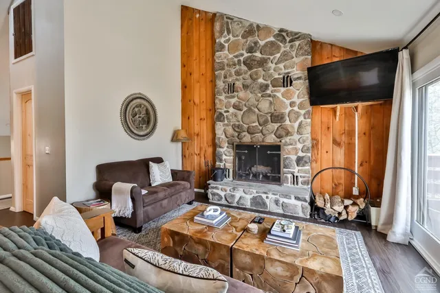 a living room with patio furniture and a fireplace