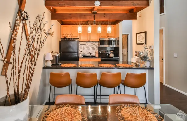 a dining room with furniture and a kitchen view