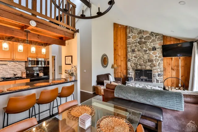 a view of a dining room with furniture wooden floor and chandelier