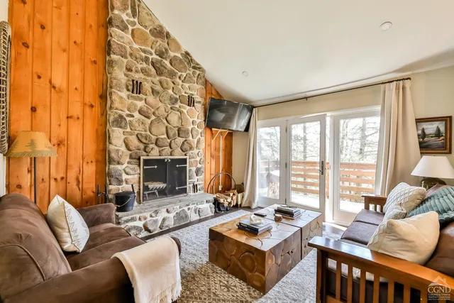 a living room with furniture wooden floor and a fireplace