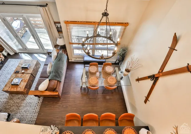 a living room with furniture and a floor to ceiling window