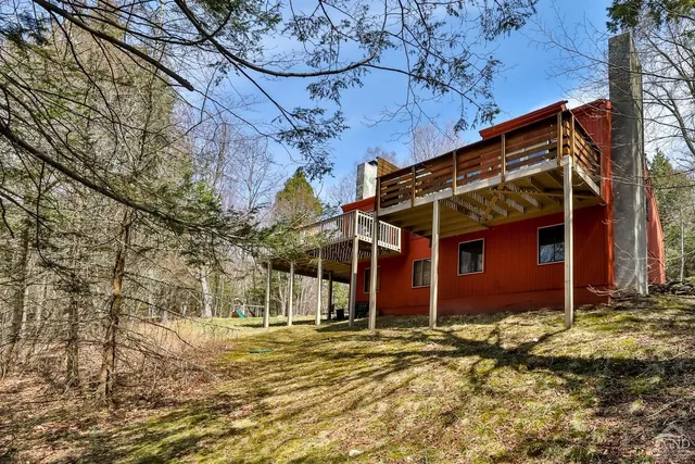 a view of a houses with snow on the road