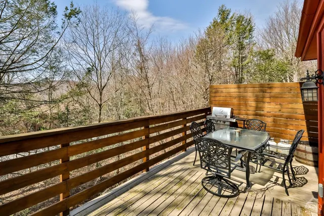 a living room with furniture a fireplace and floor to ceiling windows