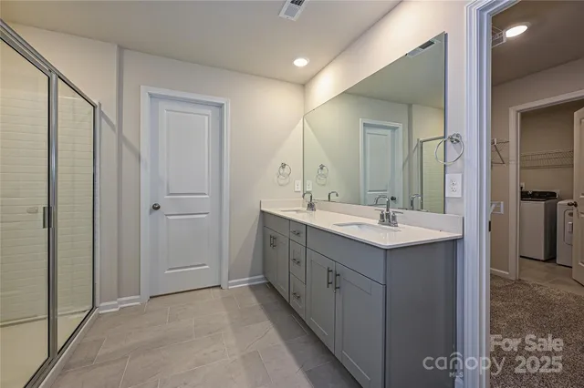 a bathroom with a double vanity sink and mirror