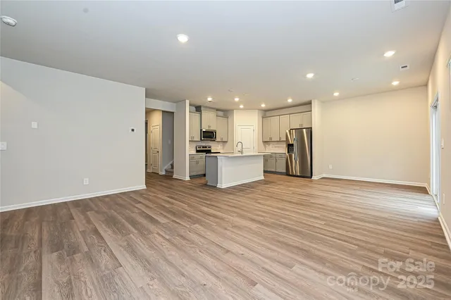 a view of a kitchen with a sink and a refrigerator