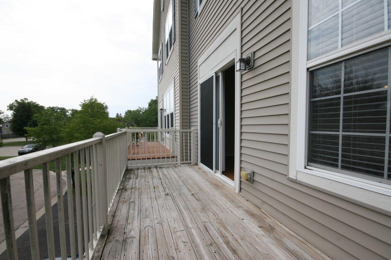114 Jackson Street Gilberts, IL 60136 - Photo 15 of 18 a view of a balcony with wooden floor and fence
