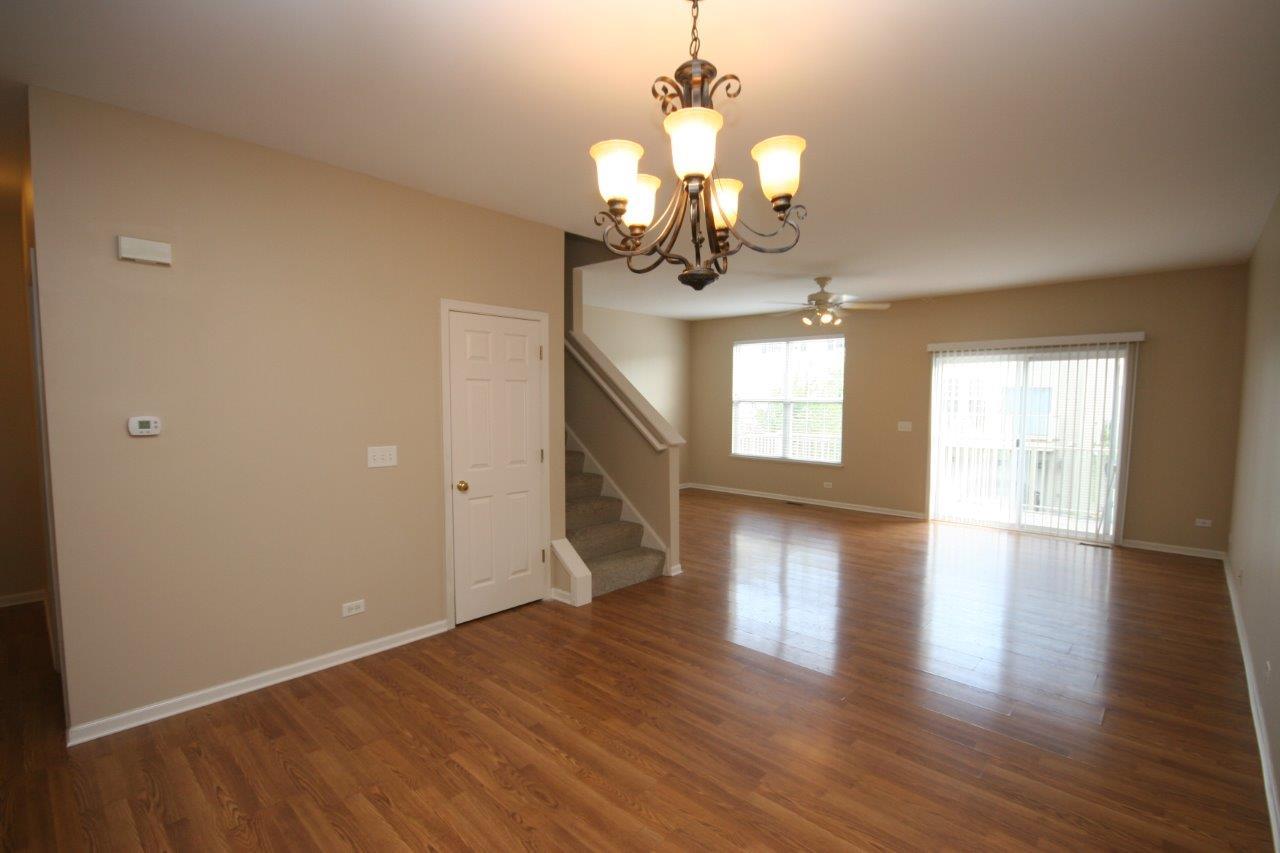 114 Jackson Street Gilberts, IL 60136 - Photo 3 of 18 a view of livingroom with chandelier and wooden floor
