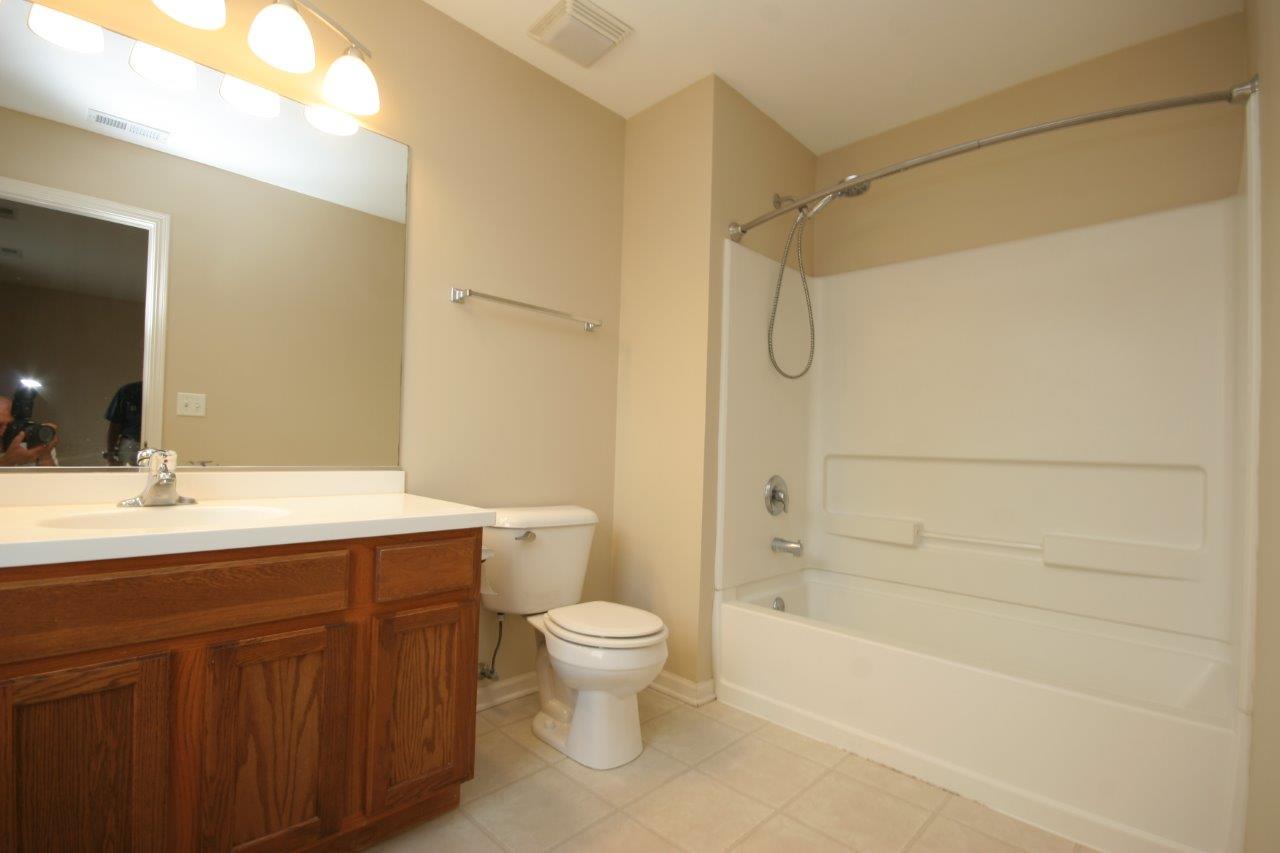 114 Jackson Street Gilberts, IL 60136 - Photo 9 of 18 a bathroom with a granite countertop sink a toilet and shower