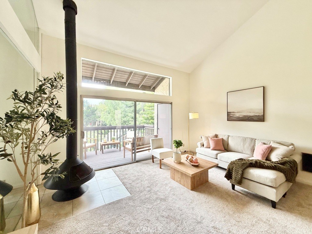 a living room with furniture and a floor to ceiling window