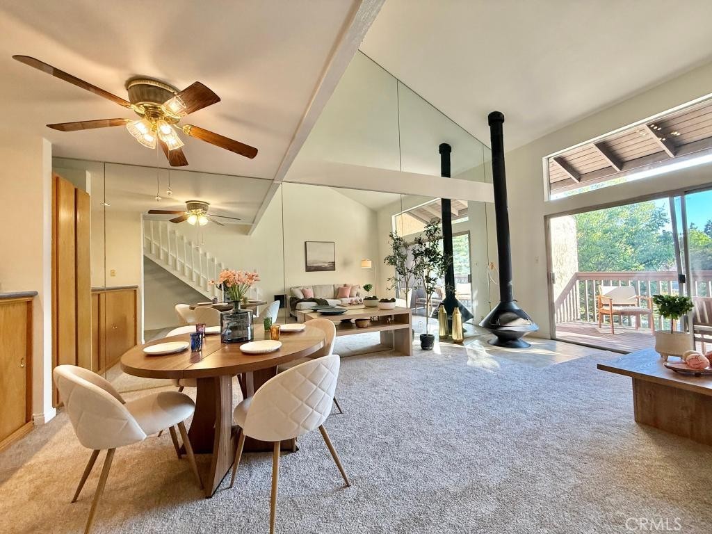 7890 East Spring Street, Unit 2F Long Beach, CA 90815 - Photo 11 of 64 a view of a dining room and livingroom with furniture wooden floor a chandelier
