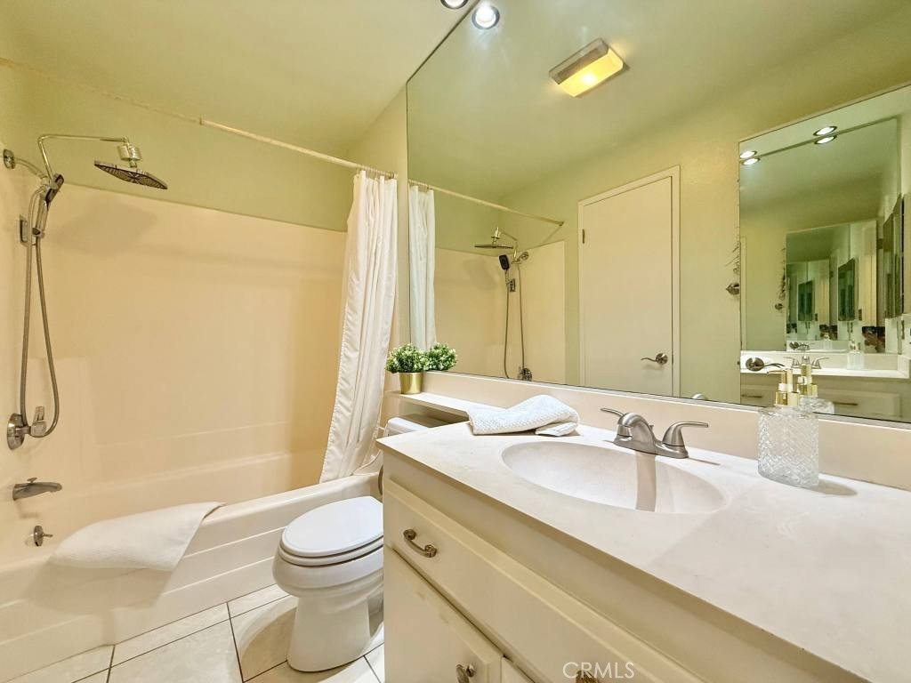 7890 East Spring Street, Unit 2F Long Beach, CA 90815 - Photo 15 of 64 a bathroom with a sink a toilet and shower