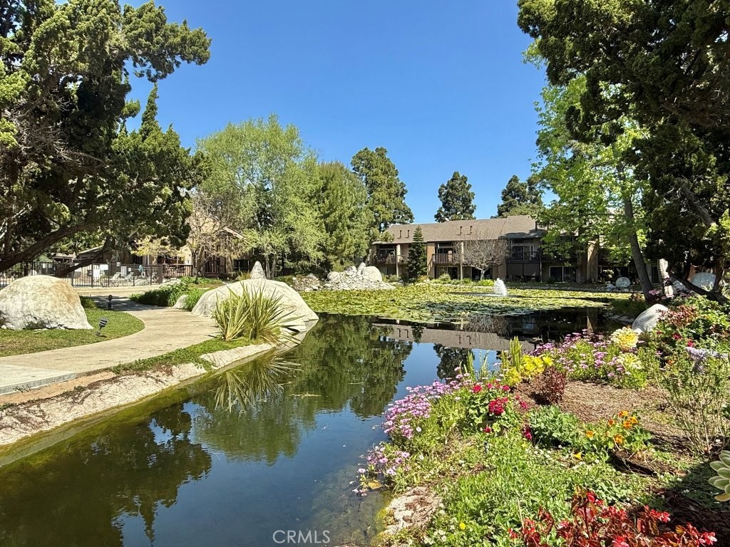7890 East Spring Street, Unit 2F Long Beach, CA 90815 - Photo 20 of 64 a view of a lake with a house in the background