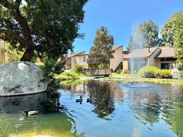 a backyard of a house with swimming pool table and chairs