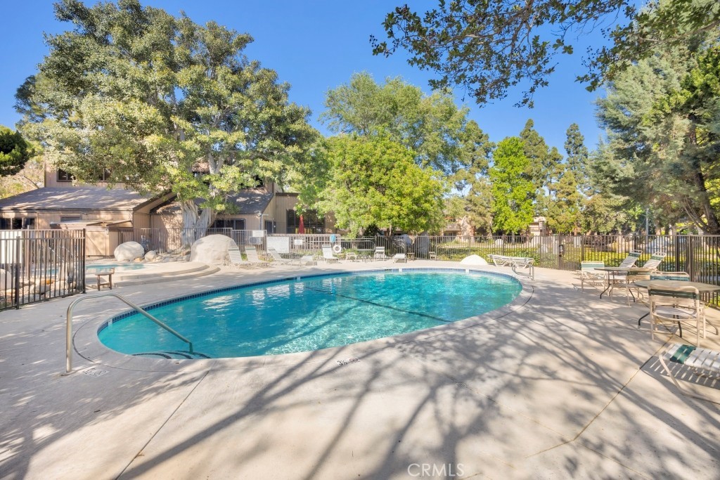 7890 East Spring Street, Unit 2F Long Beach, CA 90815 - Photo 24 of 64 a swimming pool with outdoor seating and yard