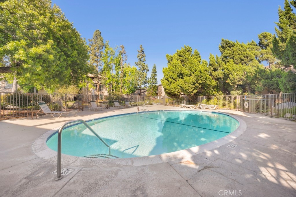 7890 East Spring Street, Unit 2F Long Beach, CA 90815 - Photo 25 of 64 a view of a swimming pool with an outdoor space and seating area