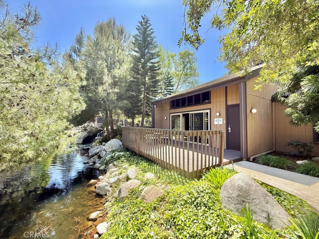 7890 East Spring Street, Unit 2F Long Beach, CA 90815 - Photo 28 of 64 a view of a house with a yard and fence