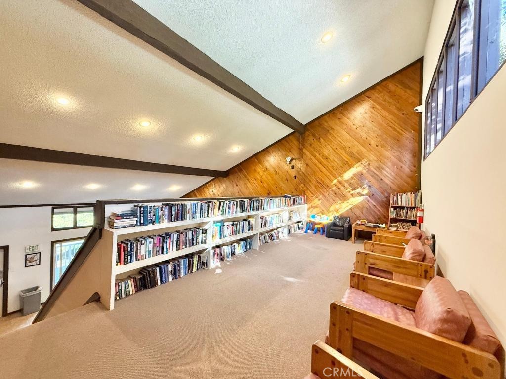 7890 East Spring Street, Unit 2F Long Beach, CA 90815 - Photo 30 of 64 a room with lots of furniture and a book shelf