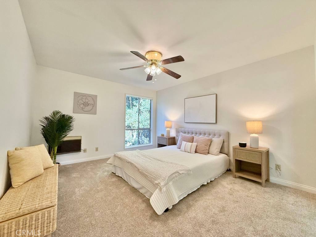 7890 East Spring Street, Unit 2F Long Beach, CA 90815 - Photo 3 of 64 a bedroom with a bed and a couch