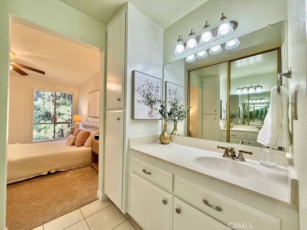 7890 East Spring Street, Unit 2F Long Beach, CA 90815 - Photo 4 of 64 a en suite bathroom with double vanity and a mirror