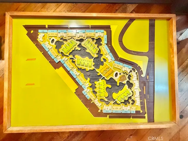 a view of a street with potted plants and a large tree