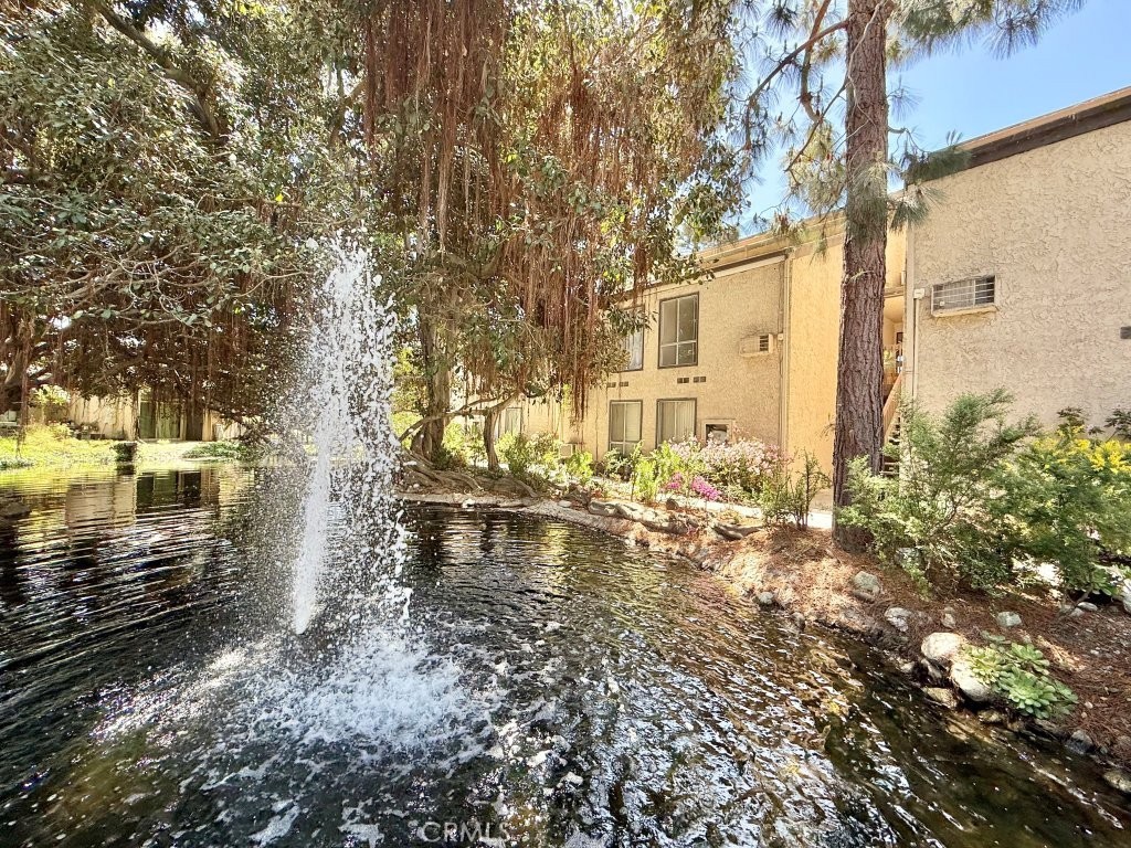 7890 East Spring Street, Unit 2F Long Beach, CA 90815 - Photo 45 of 64 a backyard of a house with a yard and outdoor seating