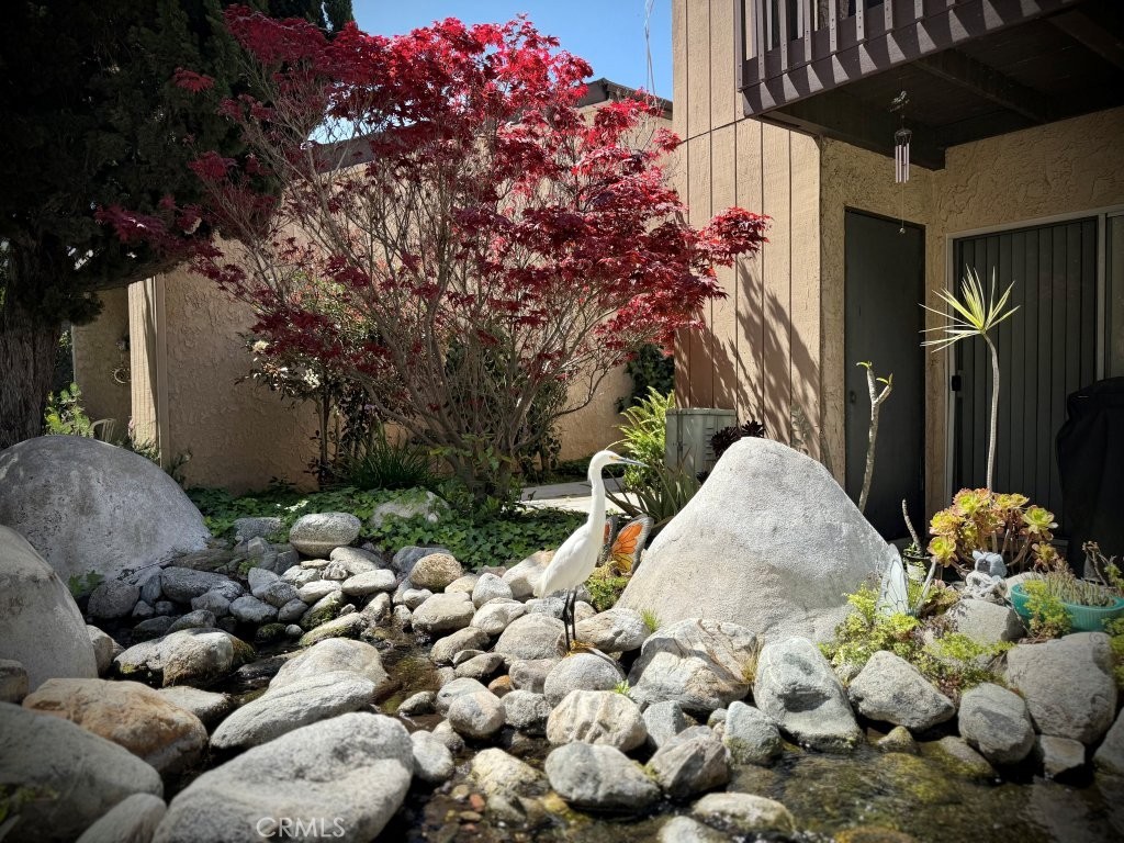 7890 East Spring Street, Unit 2F Long Beach, CA 90815 - Photo 46 of 64 a potted plant sitting in front of a house