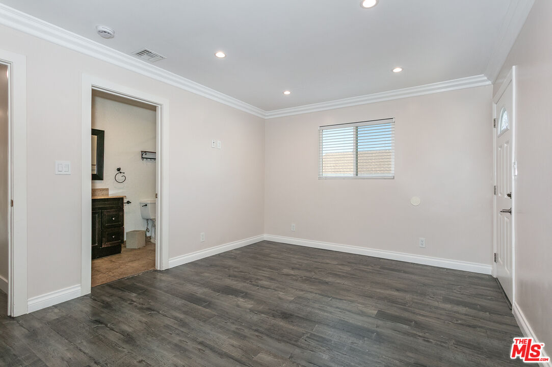 7001 Beckett Street Tujunga, CA 91042 - Photo 12 of 21 a view of an empty room with wooden floor and closet