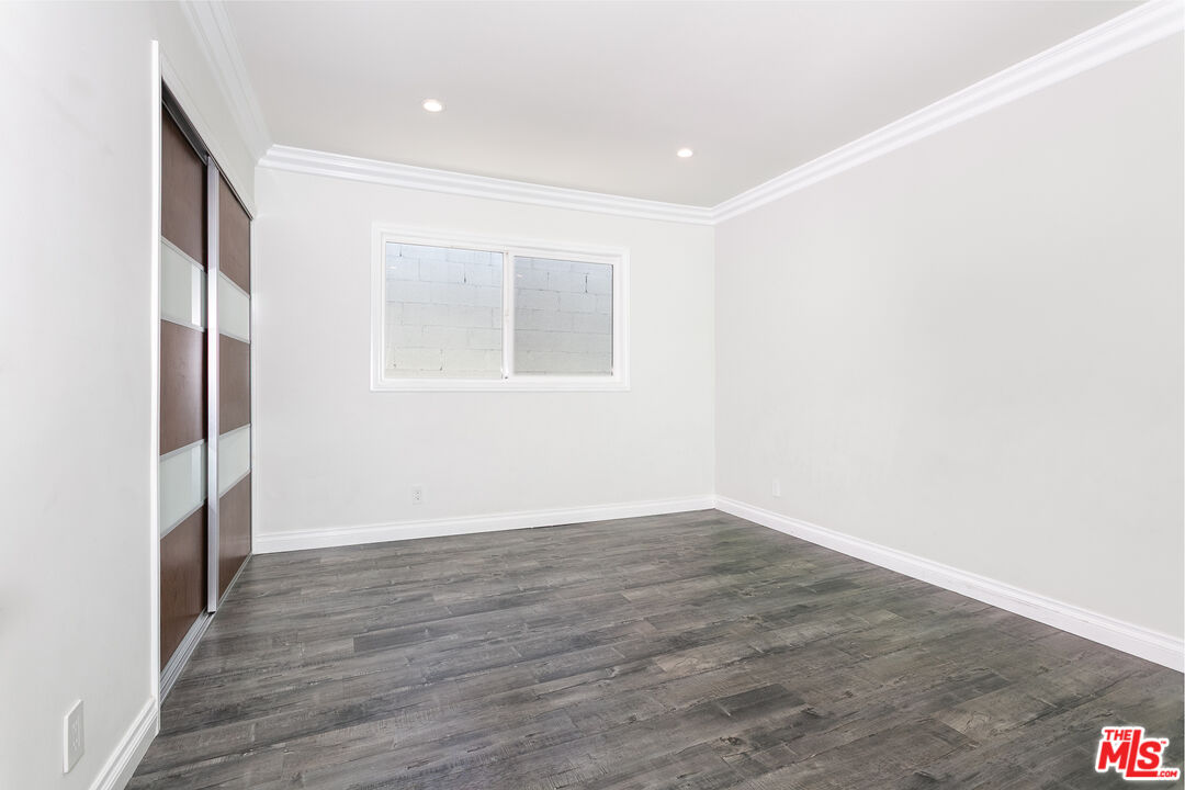 7001 Beckett Street Tujunga, CA 91042 - Photo 14 of 21 a view of an empty room with wooden floor and a window