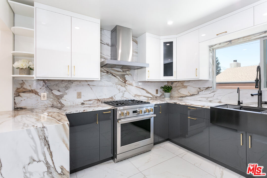 7001 Beckett Street Tujunga, CA 91042 - Photo 2 of 21 a kitchen with stainless steel appliances granite countertop a stove sink and cabinets