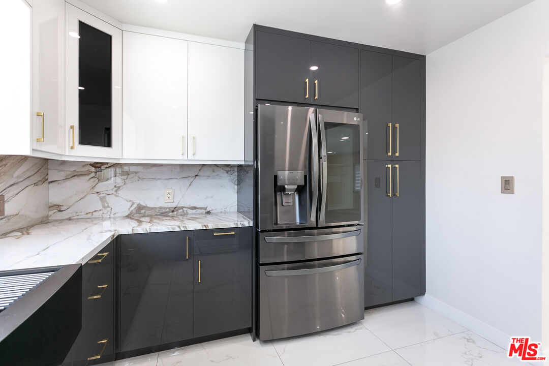 7001 Beckett Street Tujunga, CA 91042 - Photo 3 of 21 a kitchen with stainless steel appliances granite countertop a refrigerator and a sink