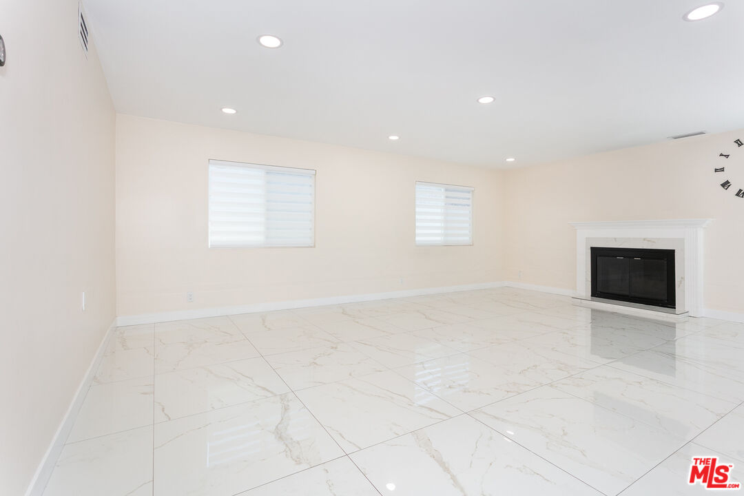 7001 Beckett Street Tujunga, CA 91042 - Photo 5 of 21 an empty room with windows and fireplace