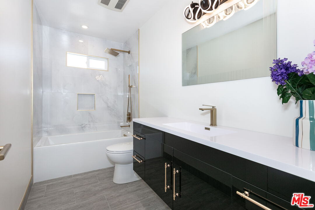 7001 Beckett Street Tujunga, CA 91042 - Photo 8 of 21 a bathroom with a sink a toilet and shower